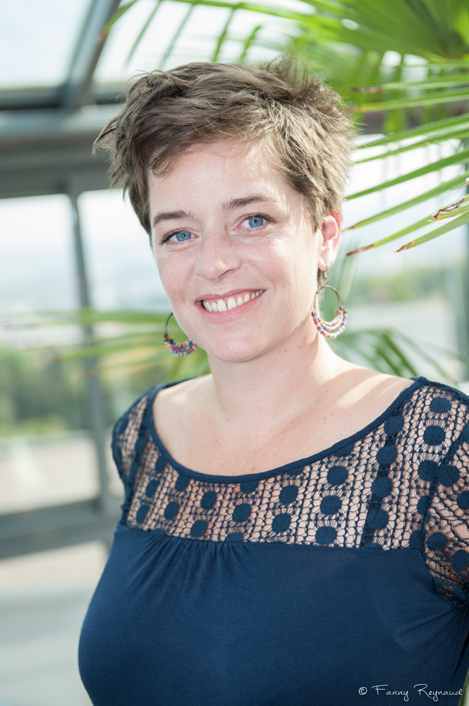 Portrait d'une jeune femme souriante lors d'une séance photo à domicile à clermont-ferrand par un photographe professionnel.